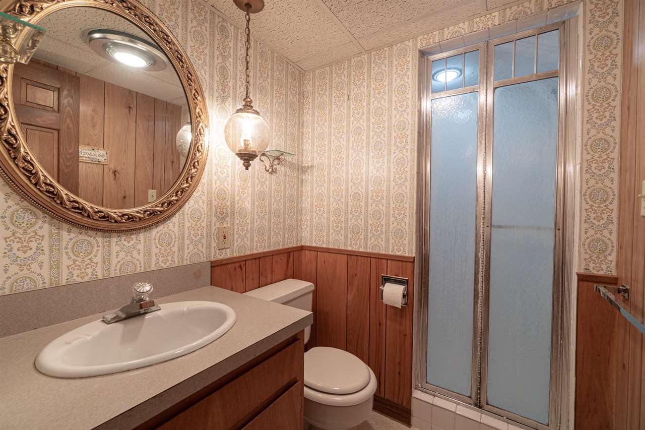 5760 Rotary Road Cherry Valley, IL 61016 - Photo 19 of 25 a bathroom with a sink a toilet and a mirror