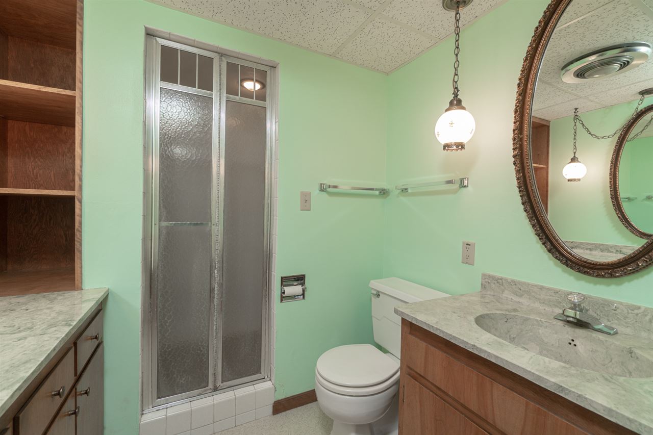 5760 Rotary Road Cherry Valley, IL 61016 - Photo 21 of 25 a bathroom with a granite countertop toilet a sink and mirror