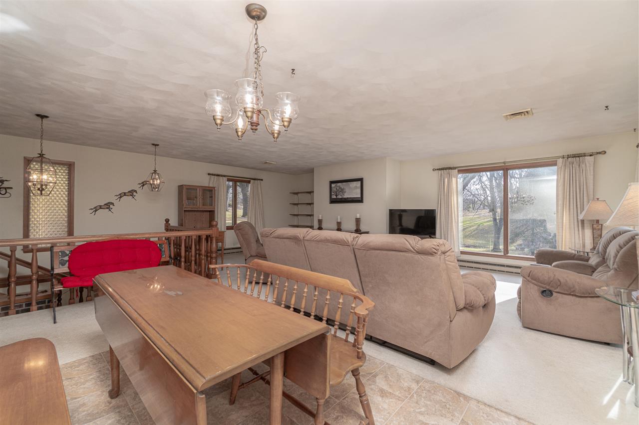 5760 Rotary Road Cherry Valley, IL 61016 - Photo 7 of 25 a living room with furniture a chandelier and a dining table