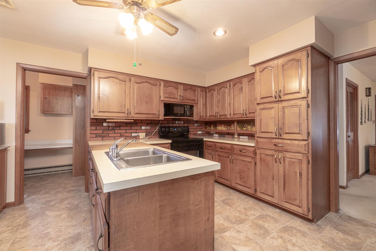 5760 Rotary Road Cherry Valley, IL 61016 - Photo 8 of 25 a kitchen with kitchen island granite countertop a sink stainless steel appliances and cabinets