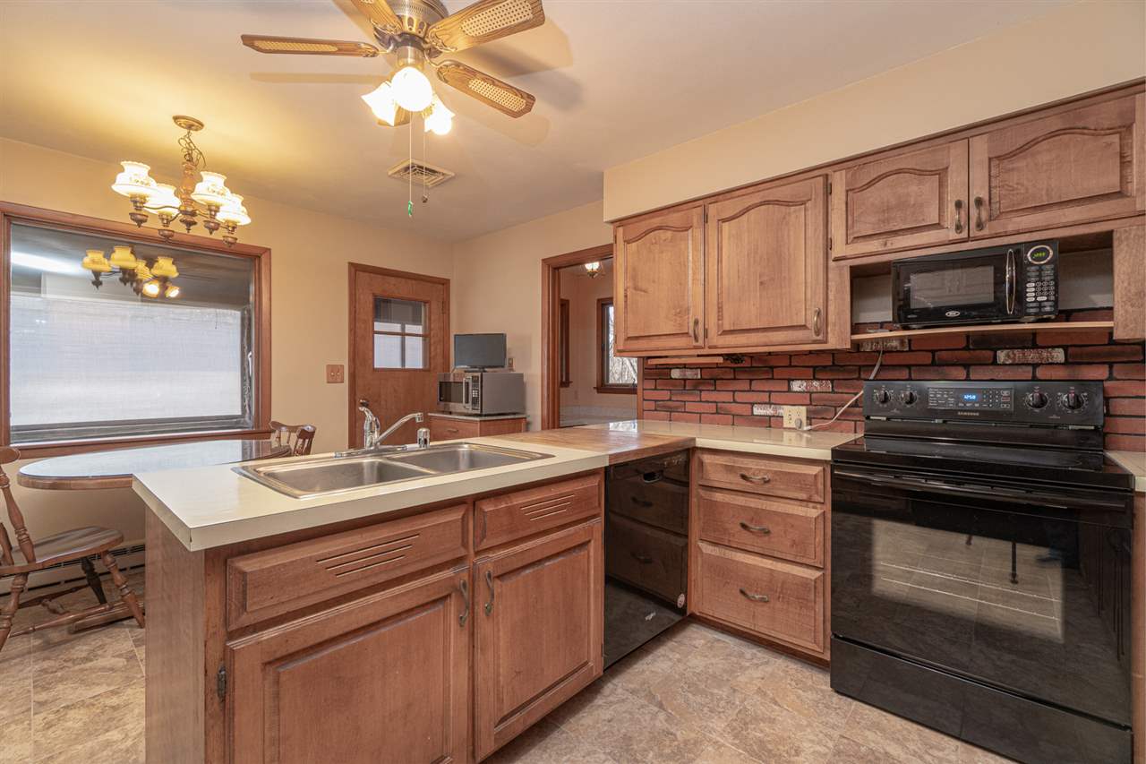 5760 Rotary Road Cherry Valley, IL 61016 - Photo 9 of 25 a kitchen with a sink stove and microwave