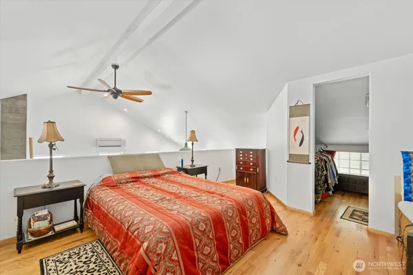 a bedroom with a bed and wooden floor