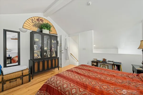 a bedroom with a bed and a large window