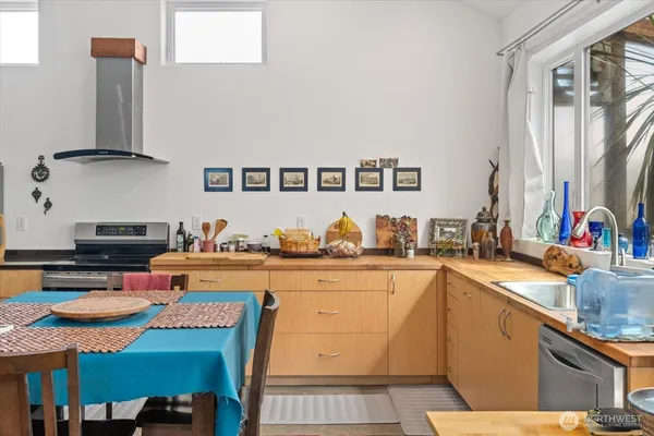 a kitchen with stainless steel appliances granite countertop a sink stove and cabinets