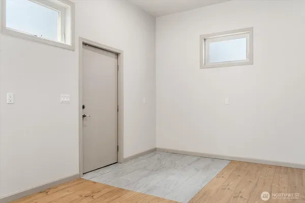 an empty room with wooden floor and closet