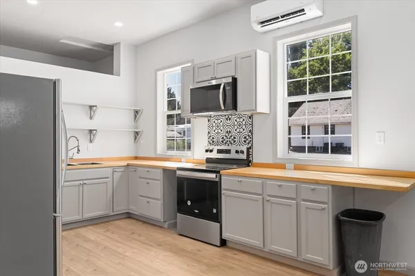 a large kitchen with a sink and large window
