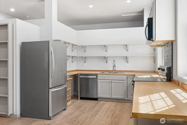 a kitchen with stainless steel appliances a refrigerator and a sink