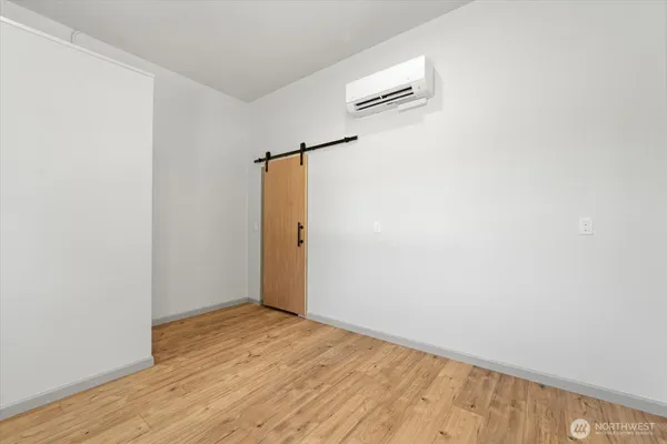 a view of a room with wooden floor