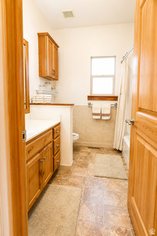1055 North 1000 East Mapleton, UT 84664 - Photo 39 of 112 Bathroom featuring a wood-finish vanity with white countertop, integrated sink, and upper cabinetry