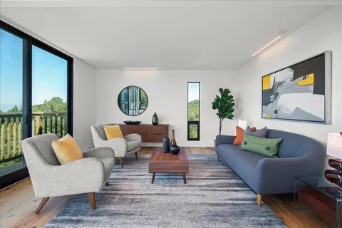 a kitchen with stainless steel appliances kitchen island granite countertop a table chairs in it and wooden floors