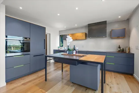 a dining room with furniture and large windows