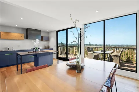 a view of a kitchen area with furniture and wooden floor