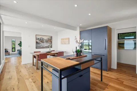 a kitchen with stainless steel appliances granite countertop a sink a counter space and a window