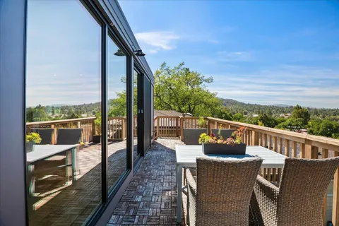 a view of a chair and table on the balcony
