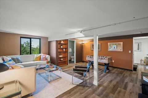 a living room with furniture and wooden floor