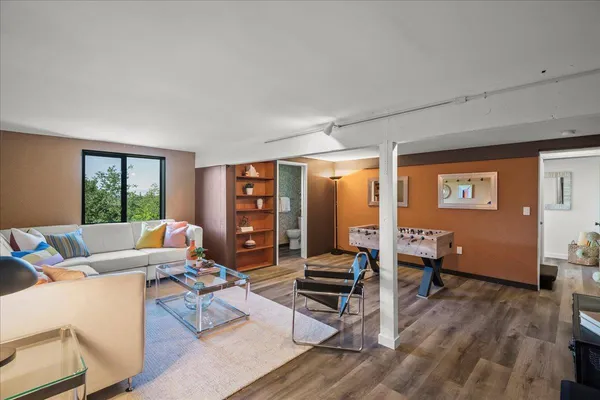 a living room with furniture and wooden floor