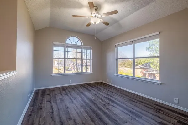 a view of a room with wooden floor and a window