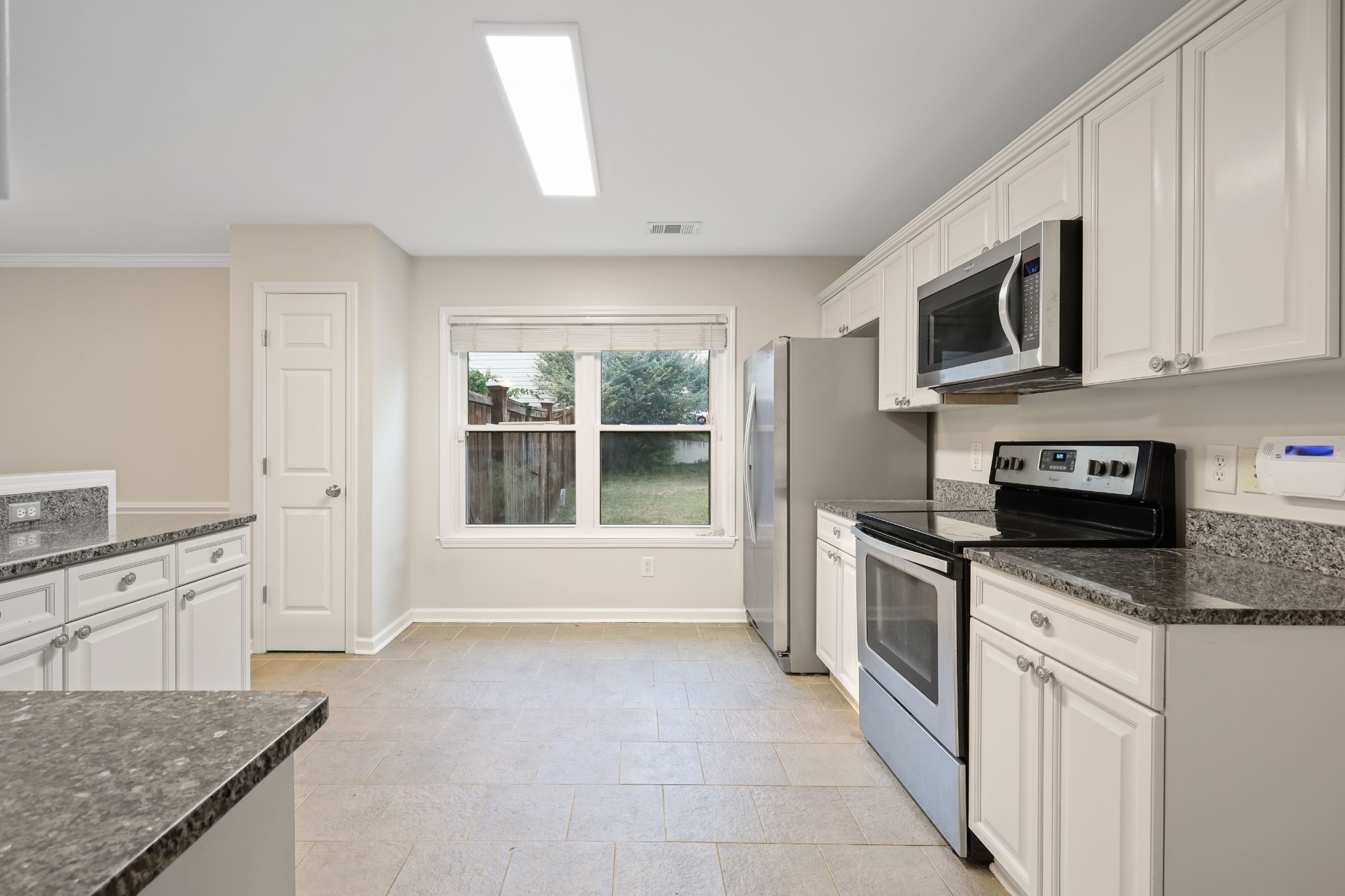 2201 Cardiff Lane Mount Juliet, TN 37122 - Photo 21 of 47 a kitchen with stainless steel appliances granite countertop a stove top oven a sink a granite counter tops and a view of living room