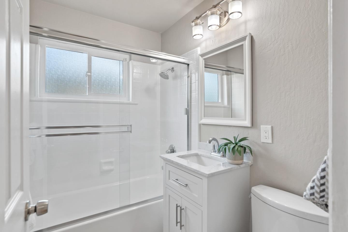 1001 Valley Forge Drive Sunnyvale, CA 94087 - Photo 15 of 24 a bathroom with a granite countertop sink toilet and shower