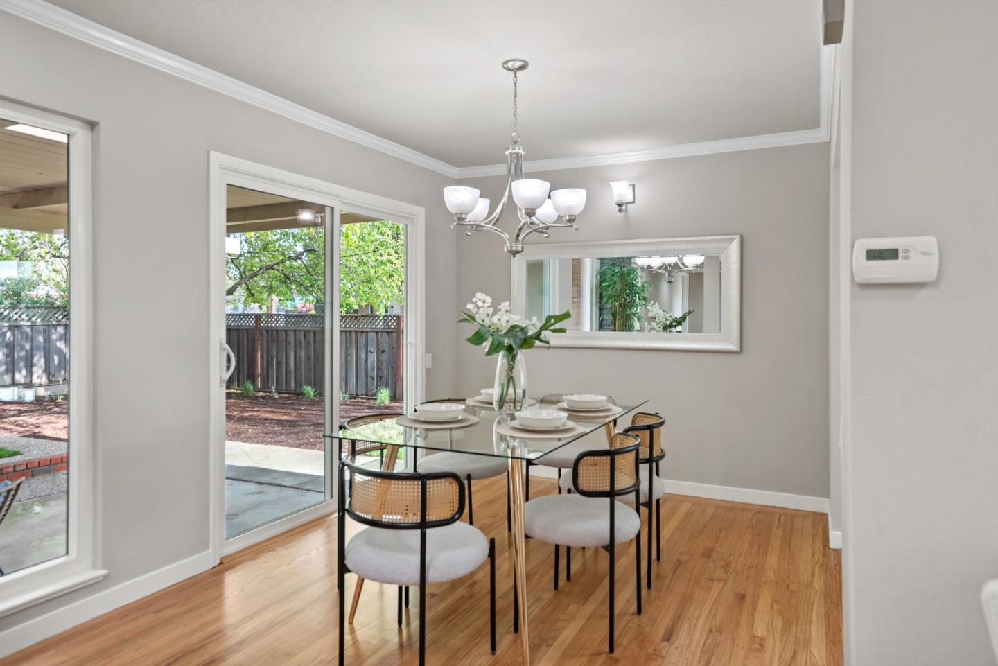 1001 Valley Forge Drive Sunnyvale, CA 94087 - Photo 6 of 24 a dining room with wooden floor a chandelier a glass table and chairs