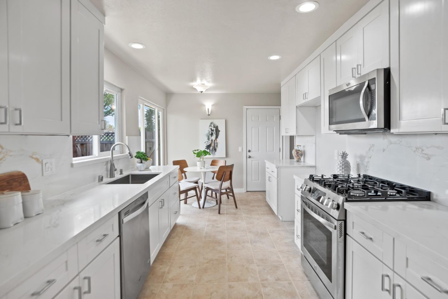 1001 Valley Forge Drive Sunnyvale, CA 94087 - Photo 8 of 24 a kitchen with stainless steel appliances a sink stove top oven and cabinets