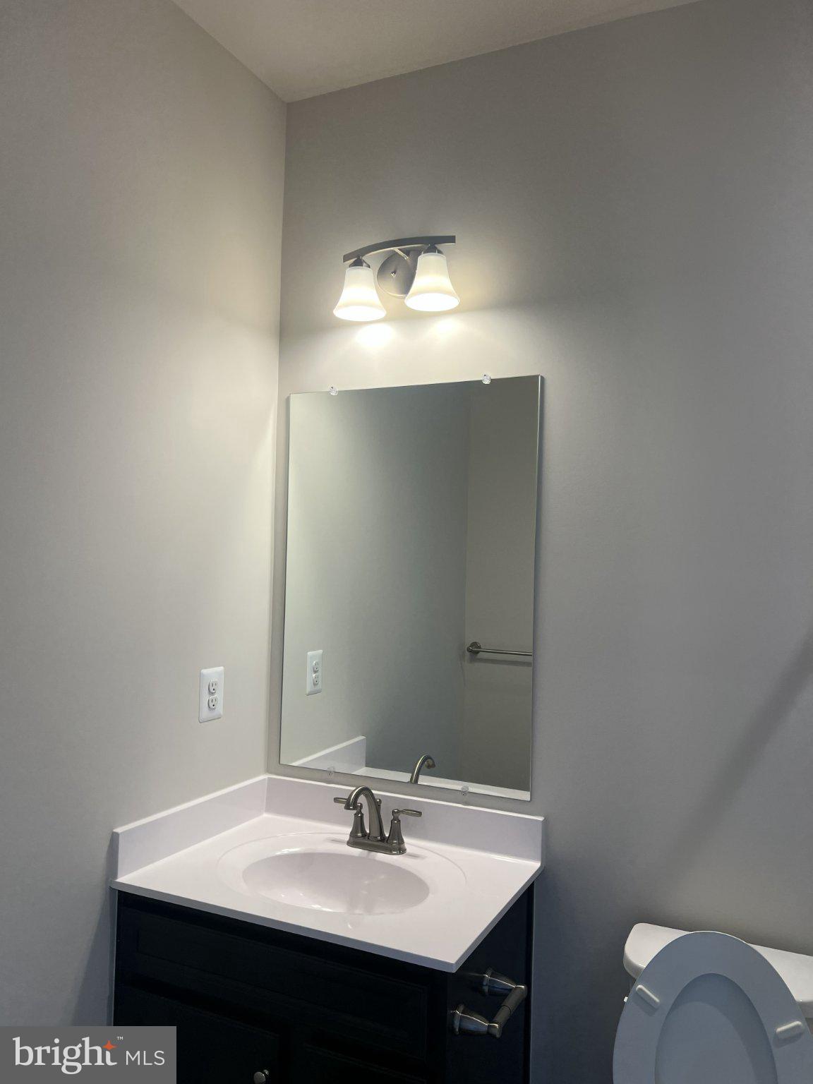 8058 Big Roundtop Road Fort George G Meade, MD 20755 - Photo 21 of 24 a bathroom with a sink and a mirror