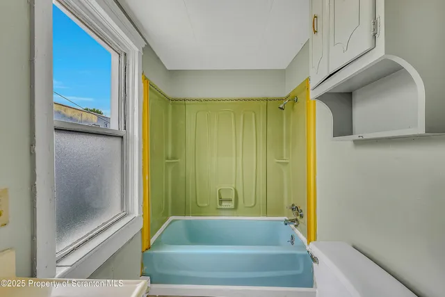 a bathroom with a bathtub and shower