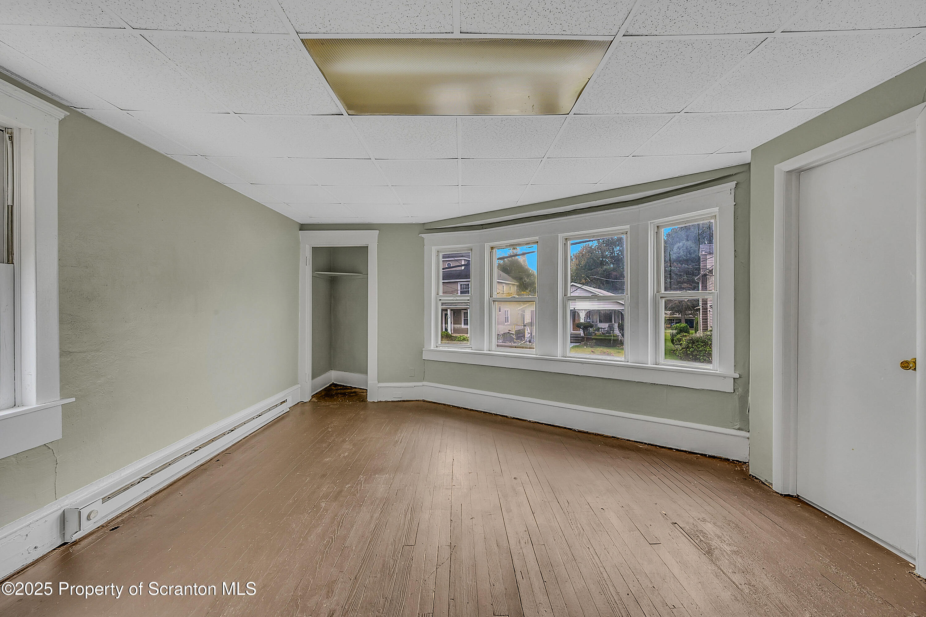 627 Main Street Duryea, PA 18642 - Photo 15 of 26 an empty room with wooden floor and windows