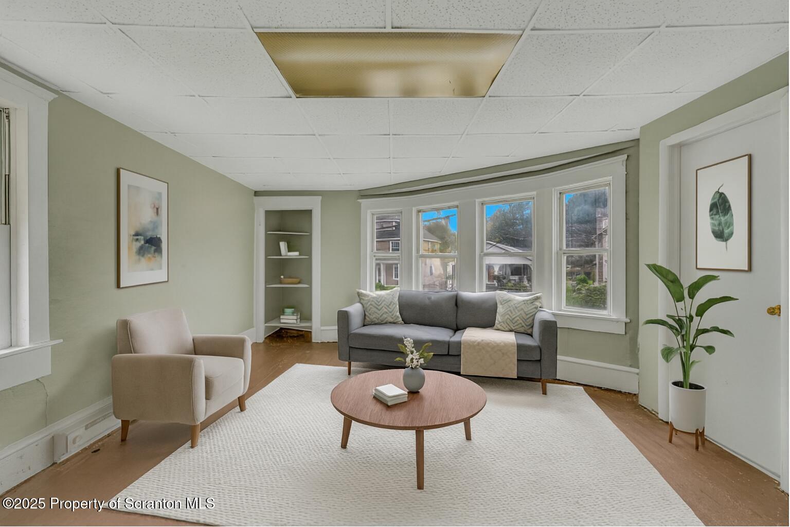 627 Main Street Duryea, PA 18642 - Photo 16 of 26 a living room with furniture potted plant and a large window