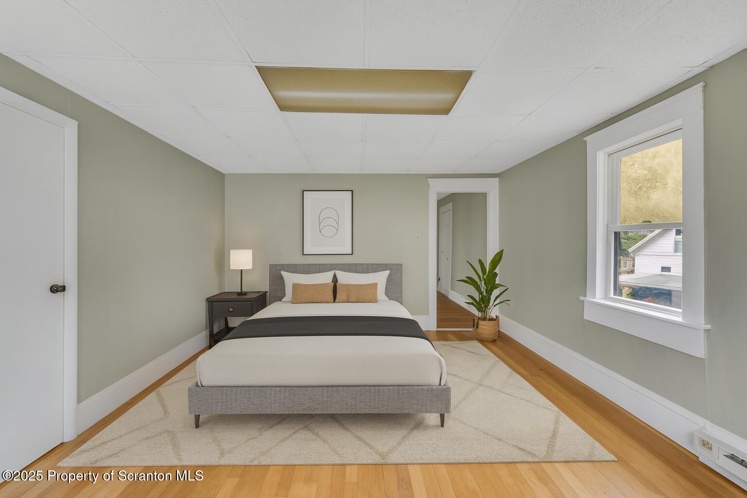 627 Main Street Duryea, PA 18642 - Photo 18 of 26 a spacious bedroom with a large bed and a window