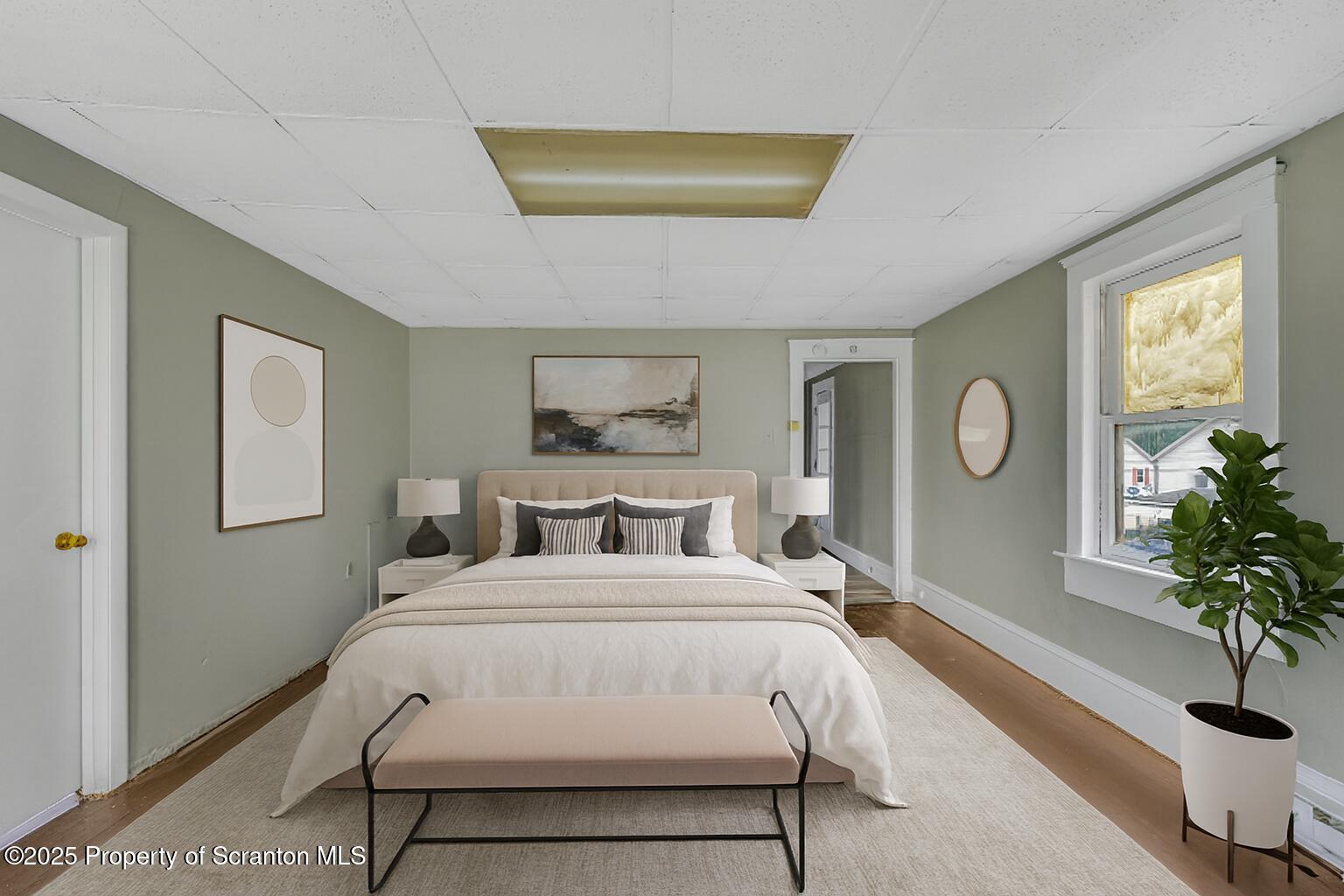 627 Main Street Duryea, PA 18642 - Photo 19 of 26 a bedroom with a bed and a potted plant