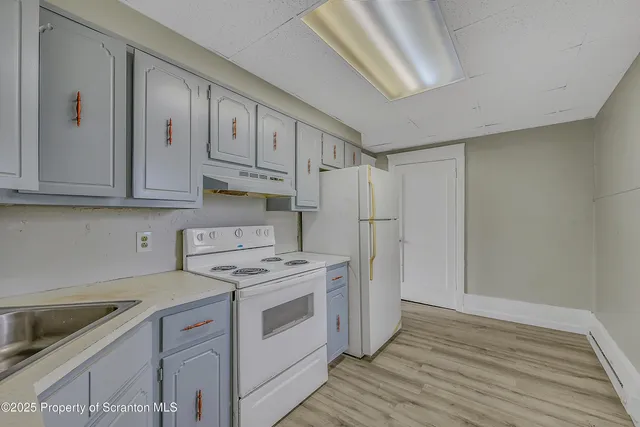 a kitchen with stainless steel appliances granite countertop a refrigerator and a stove