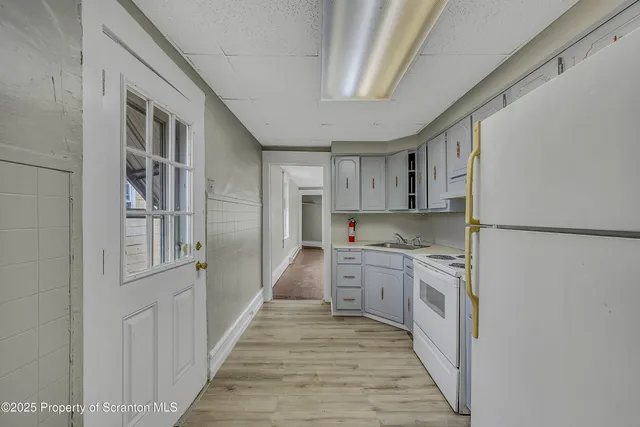 a kitchen with stainless steel appliances granite countertop a refrigerator and a stove