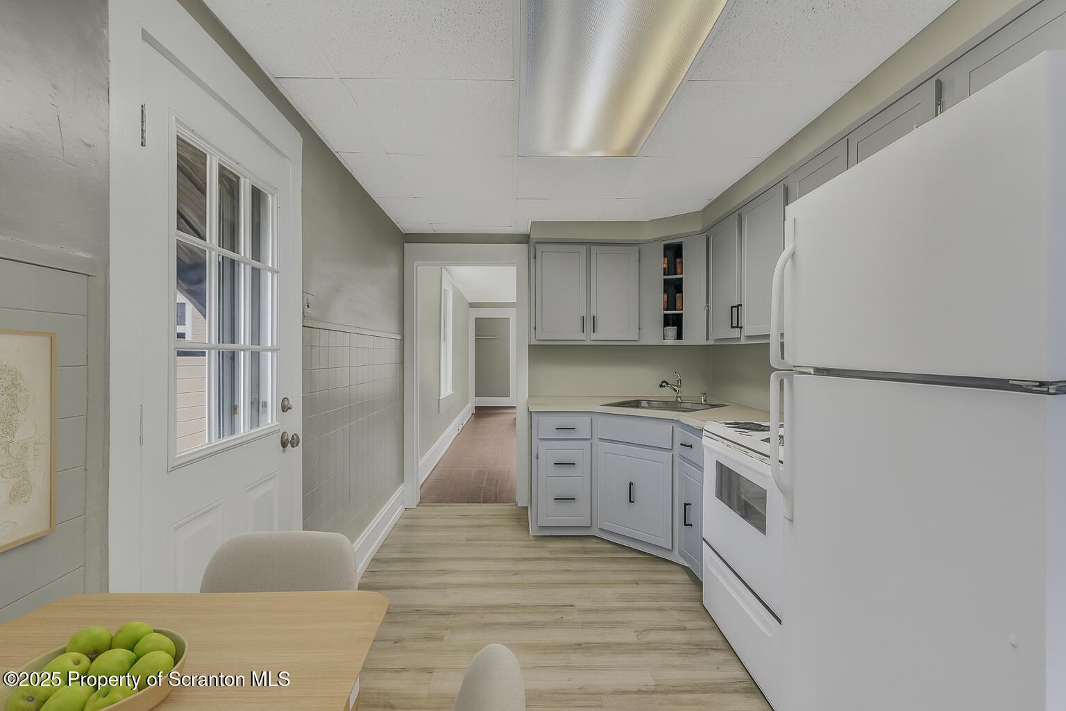 627 Main Street Duryea, PA 18642 - Photo 22 of 26 a large white kitchen with granite countertop a sink