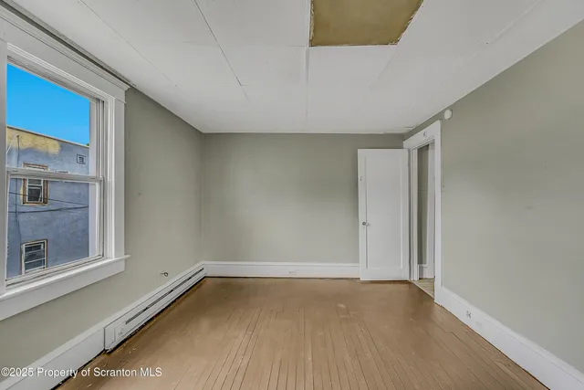 a view of an empty room with a window