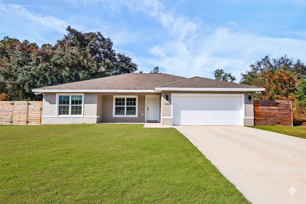 front view of a house and a yard with trees