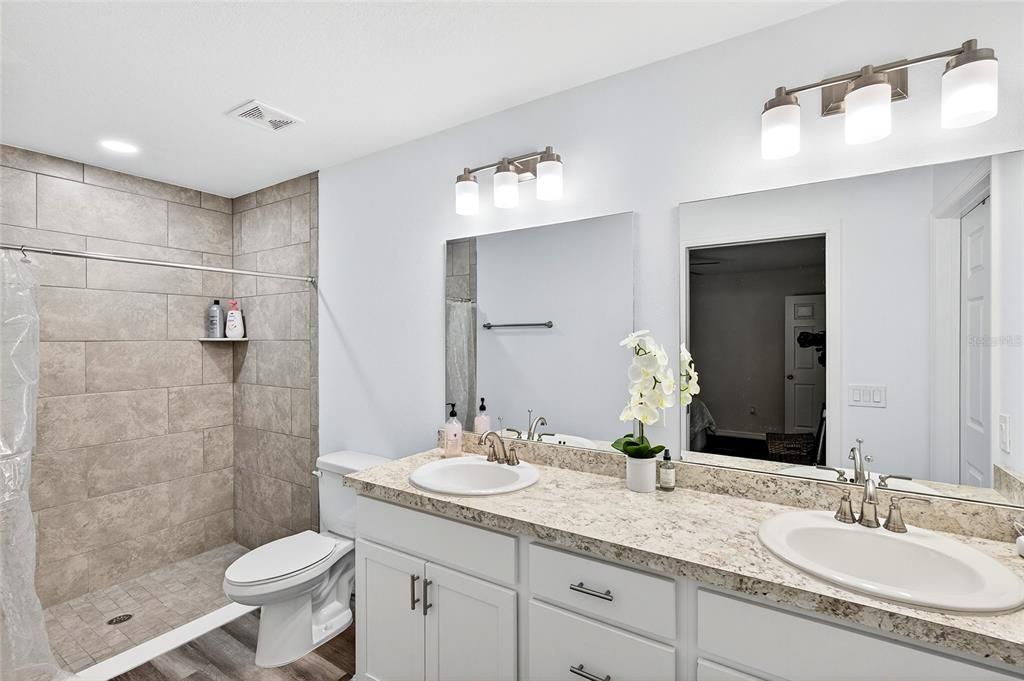 14862 Southwest 79 Terrace Road Dunnellon, FL 34432 - Photo 13 of 28 a bathroom with a granite countertop sink toilet and shower