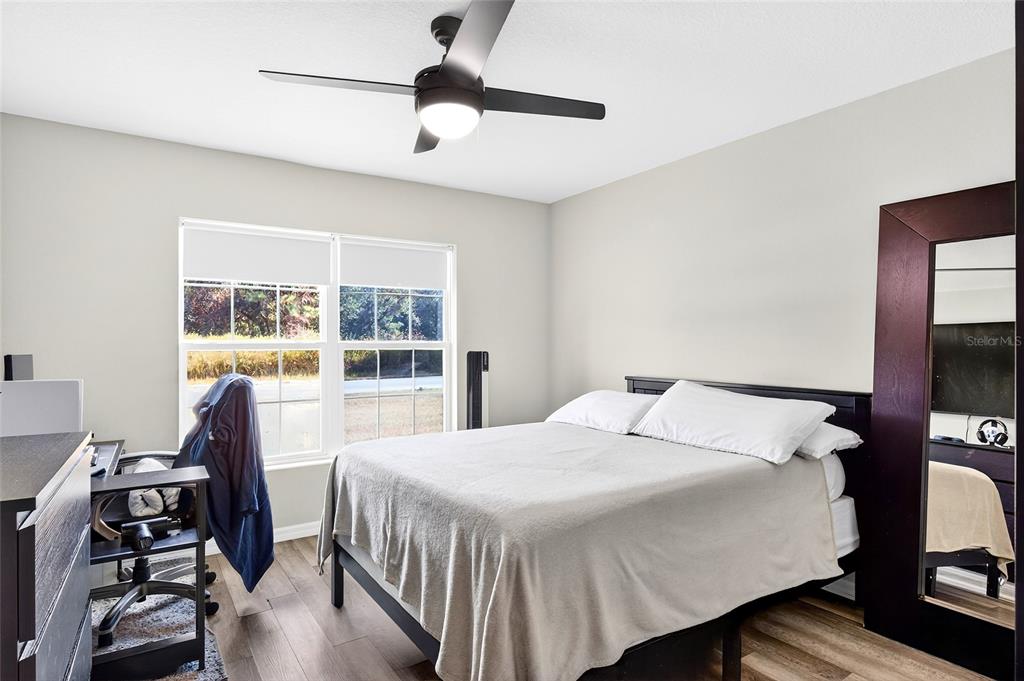 14862 Southwest 79 Terrace Road Dunnellon, FL 34432 - Photo 18 of 28 a bedroom with a bed and a large window