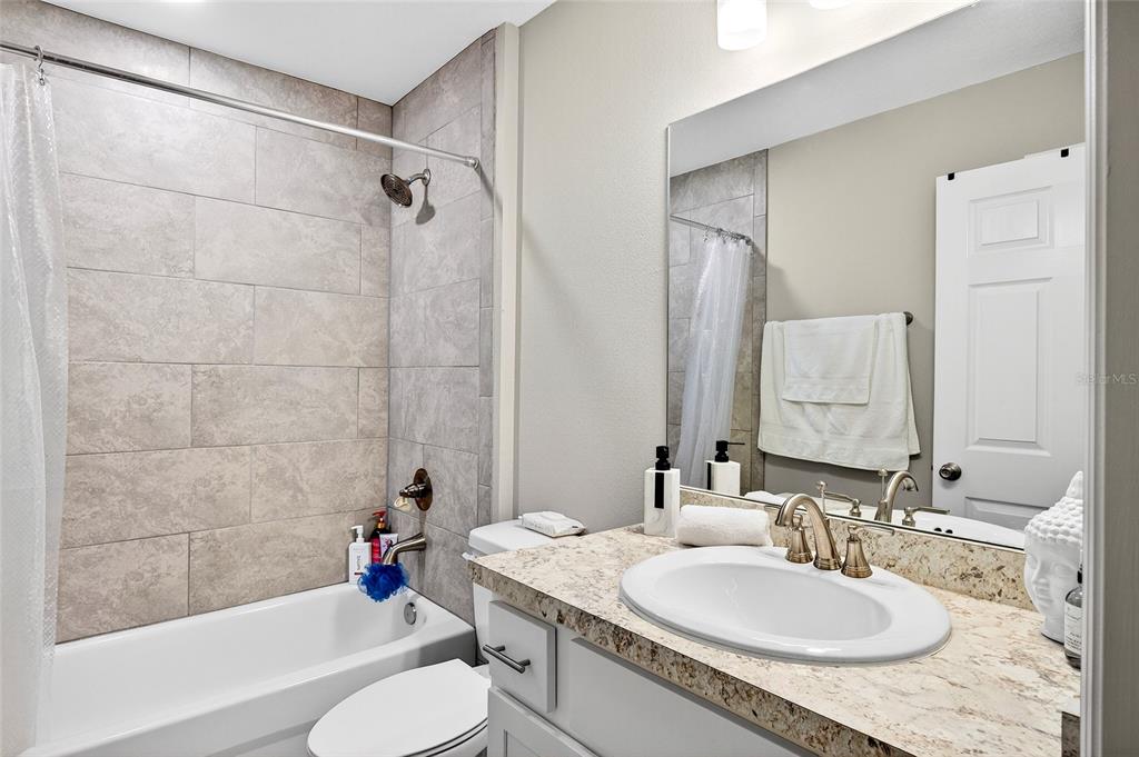 14862 Southwest 79 Terrace Road Dunnellon, FL 34432 - Photo 20 of 28 a bathroom with a granite countertop sink toilet and shower