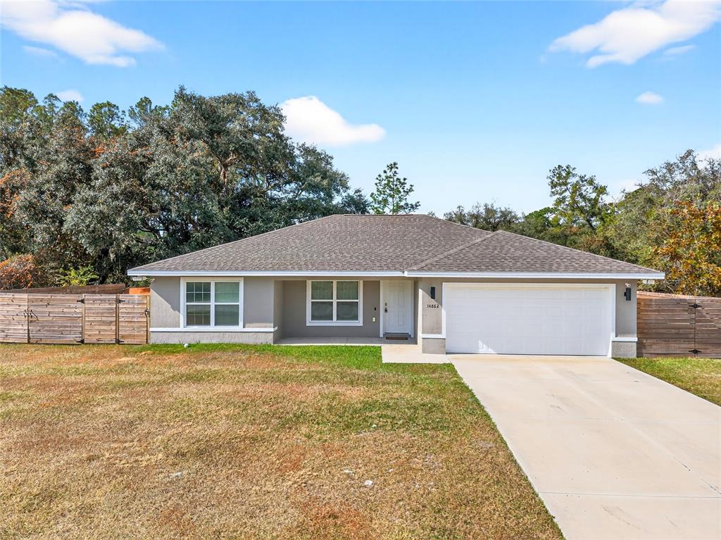 14862 Southwest 79 Terrace Road Dunnellon, FL 34432 - Photo 2 of 28 front view of a house and a yard