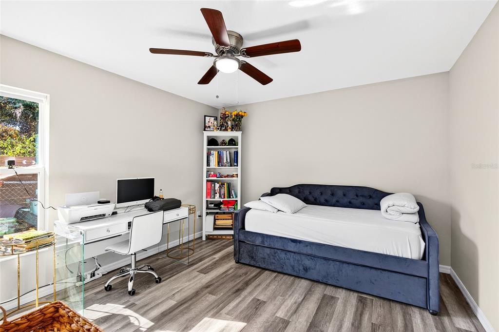 14862 Southwest 79 Terrace Road Dunnellon, FL 34432 - Photo 21 of 28 a bedroom with a bed and a desk in it