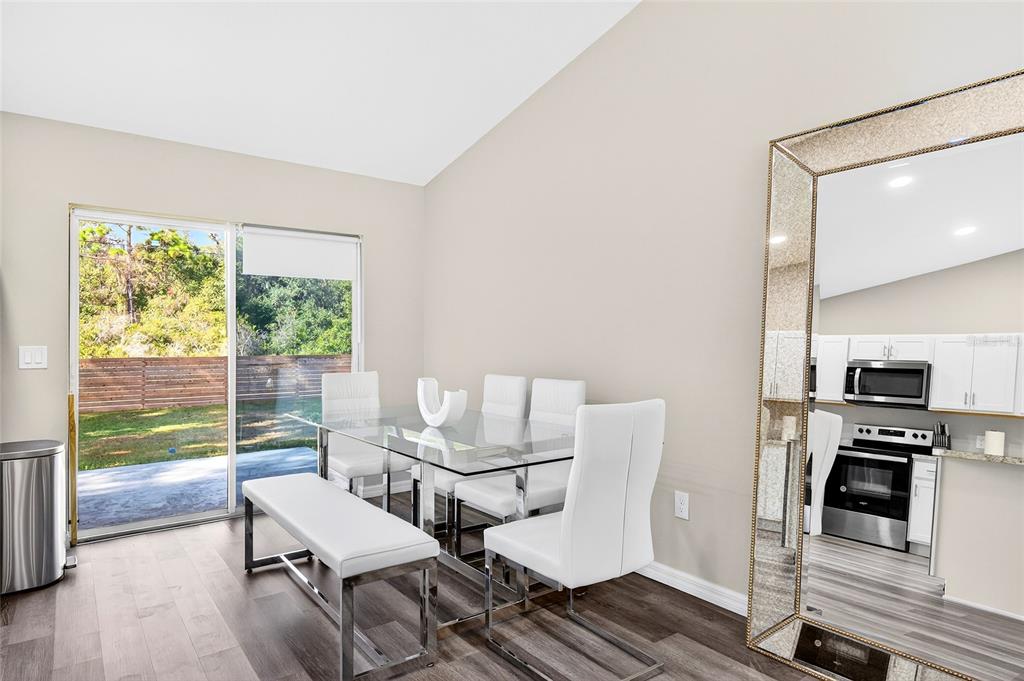 14862 Southwest 79 Terrace Road Dunnellon, FL 34432 - Photo 24 of 28 a dining room with furniture and wooden floor