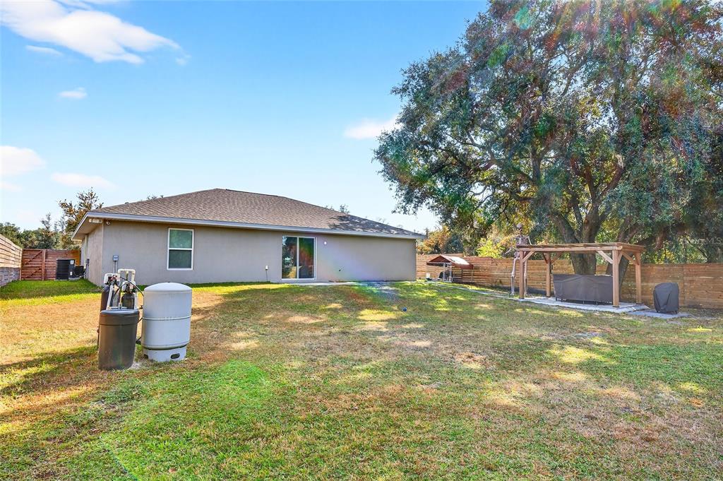 14862 Southwest 79 Terrace Road Dunnellon, FL 34432 - Photo 25 of 28 a view of a house with a yard and large tree