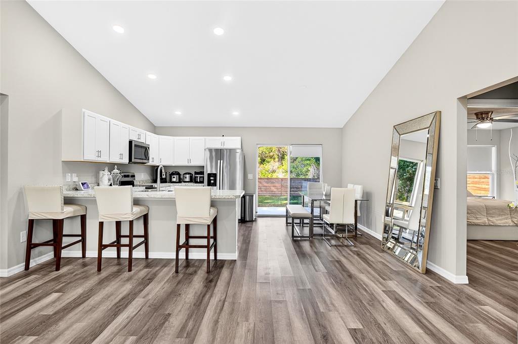 14862 Southwest 79 Terrace Road Dunnellon, FL 34432 - Photo 7 of 28 a living room with lots of furniture and kitchen view with wooden floor