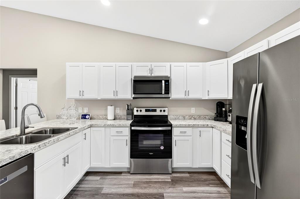 14862 Southwest 79 Terrace Road Dunnellon, FL 34432 - Photo 9 of 28 a kitchen with a sink a stove and refrigerator