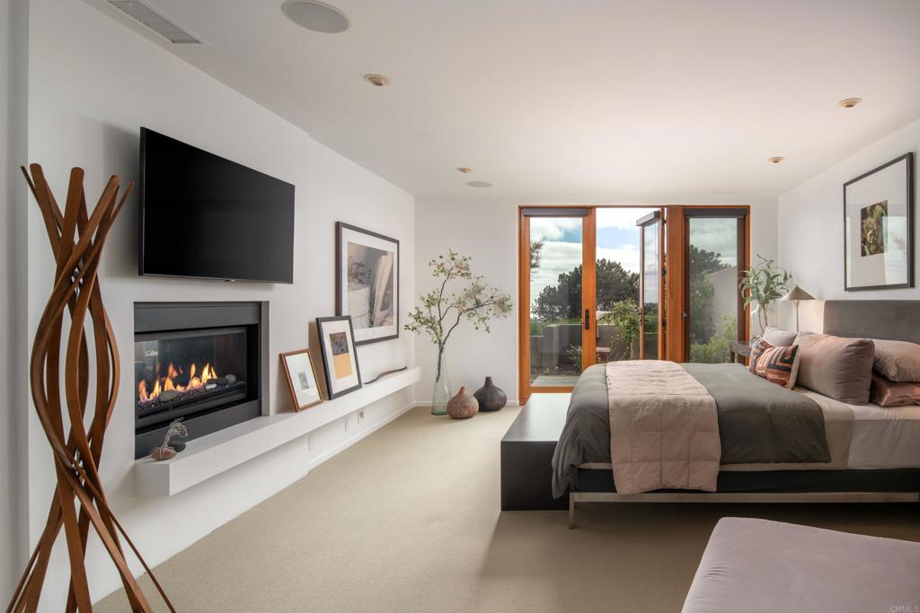 14014 Rue D Antibes Del Mar, CA 92014 - Photo 20 of 46 a spacious bedroom with a bed and a flat screen tv