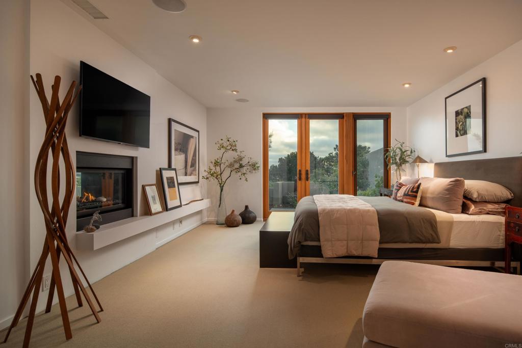 14014 Rue D Antibes Del Mar, CA 92014 - Photo 21 of 46 a spacious bedroom with two beds and a flat screen tv