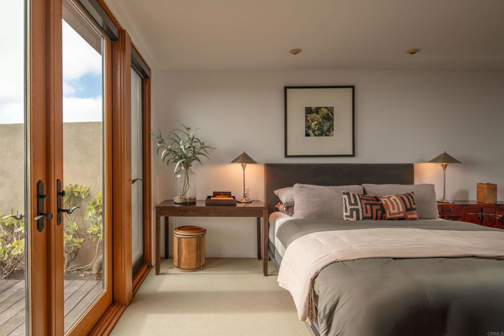 14014 Rue D Antibes Del Mar, CA 92014 - Photo 22 of 46 a bedroom with a large bed and a chandelier