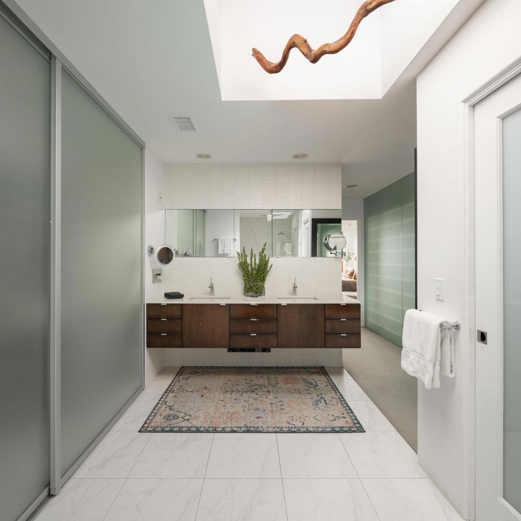 14014 Rue D Antibes Del Mar, CA 92014 - Photo 25 of 46 a bathroom with a double vanity sink and a mirror