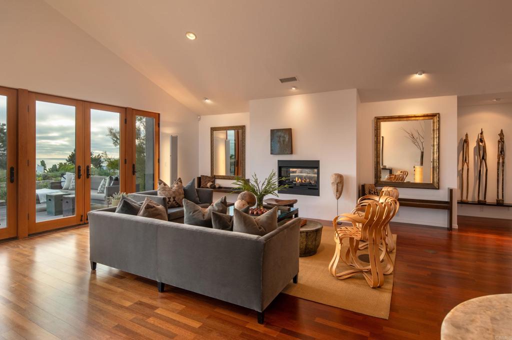 14014 Rue D Antibes Del Mar, CA 92014 - Photo 6 of 46 a living room with fireplace furniture and floor to ceiling windows